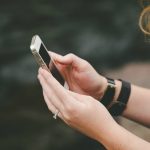 Woman on phone by river