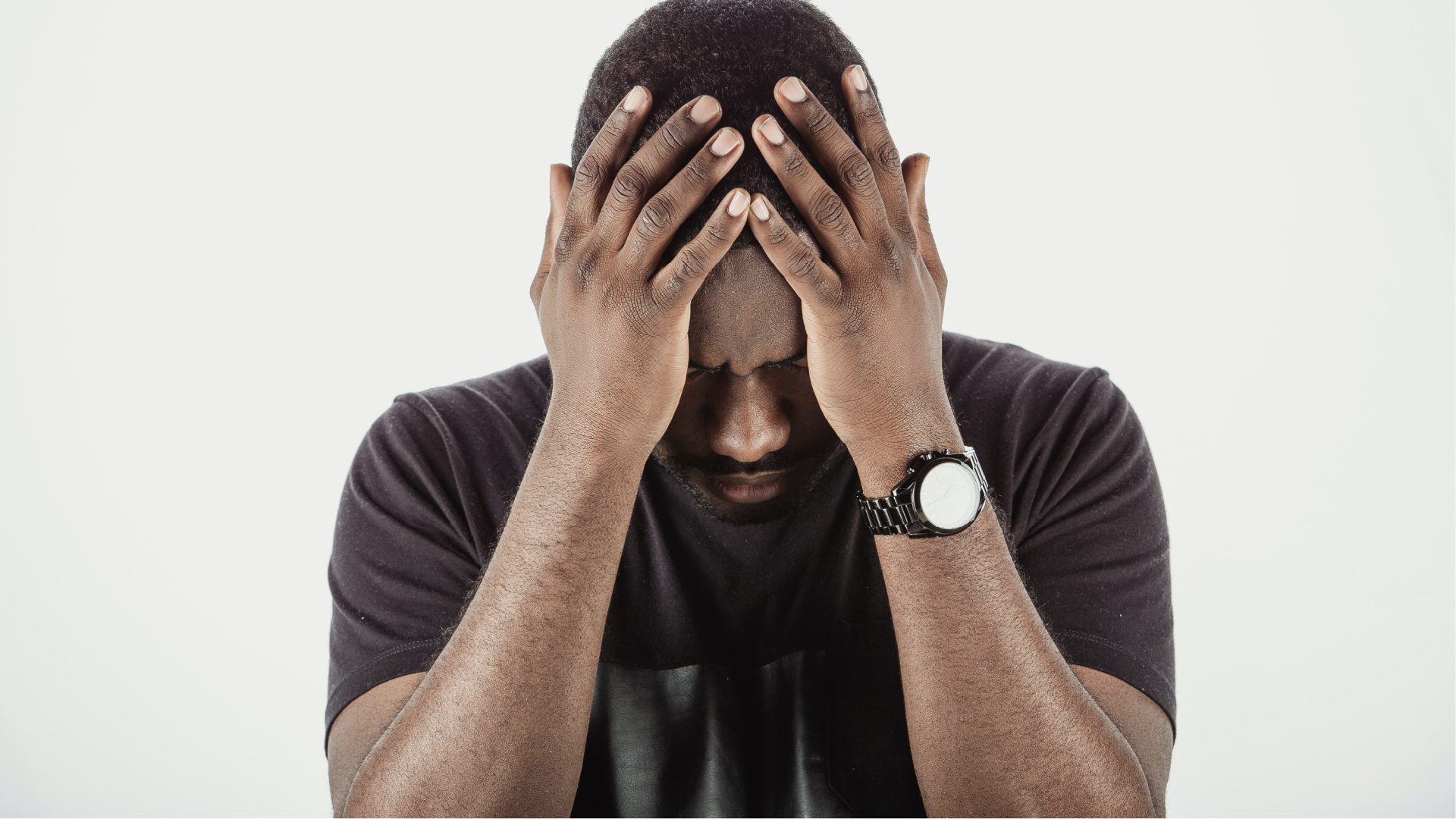 Man in grief with hands on head