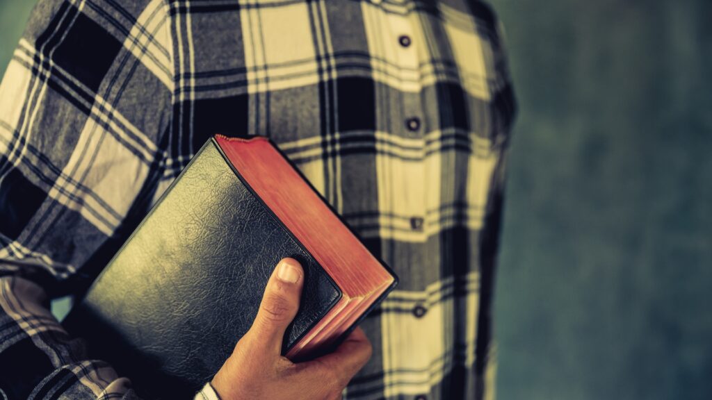 man holding Bible