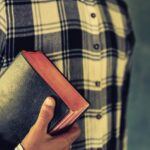 man holding Bible