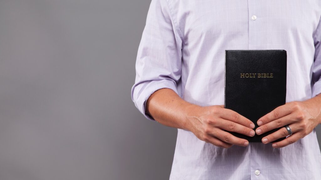 man holding Bible