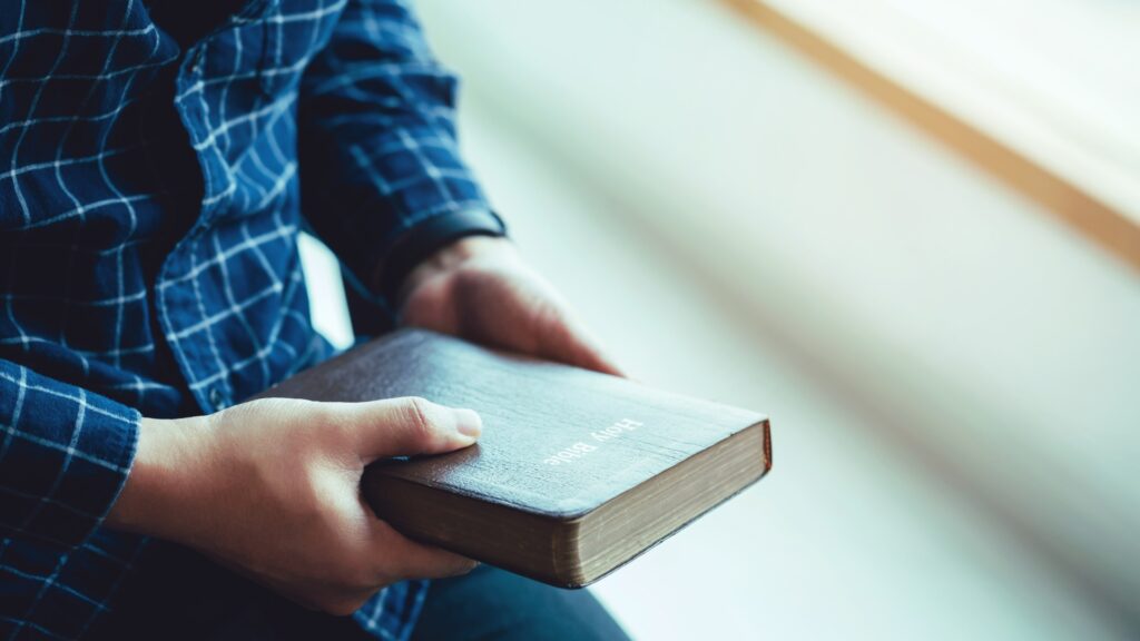 man holding Bible