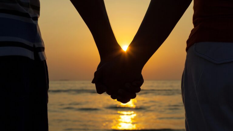 holding hands sunset