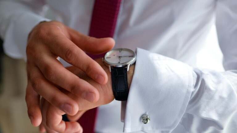 man looks at watch