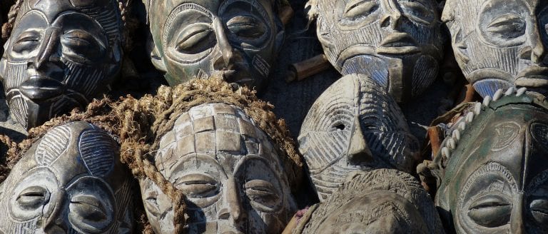 Witchcraft in Africa - image of carved wooden masks all together and on-top of each other