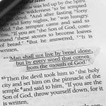 Photo of The Bible with text underlined "Man shall not live by bread alone"