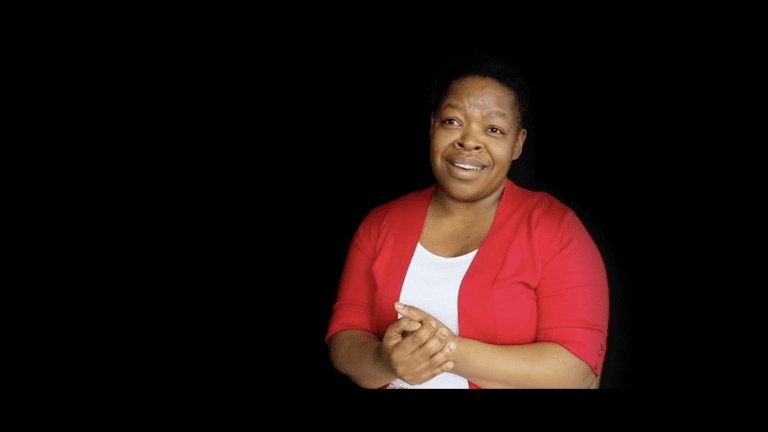 Dudu on black background talking about God's faithfulness in her total life change