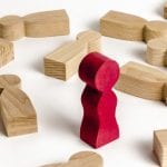 Church Members we could do without - Red block standing with wooden blocks fallen flat