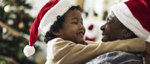 Be attentive to others at Christmas - man and child in Christmas hats