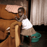 Called to Care? Ugandan child and broken chair