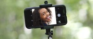 Selfie image - African woman on phone screen