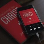 Coronavirus and Christ: Book cover on iphone and tablet screens lying in a pile