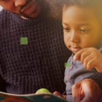 Getting Started Right - small African child reading a book with Dad