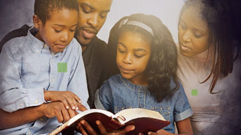 Family Devotions - African family gathered around a Bible