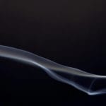 Ancestral worship - wisp of incense smoke on a black background