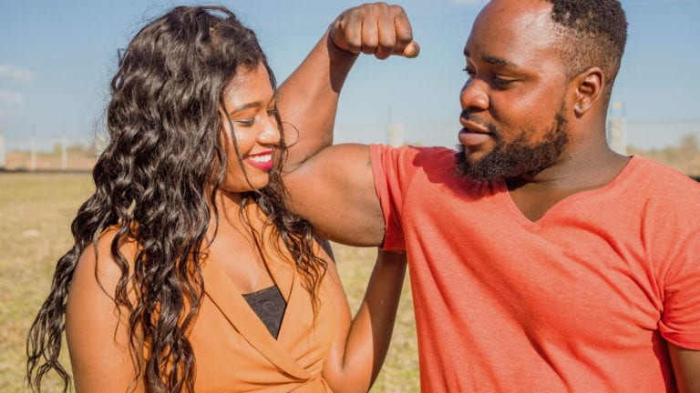 Zambian Couple - Man flexing his bicep as woman hugs him. Are Faithful husbands weak?