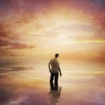 African man standing in water at sunset - does a dream mean something?