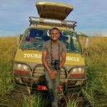 Expository preaching is like being a local in a tourist attraction - Ugandan tourist guide leaning on his vehicle in the veld