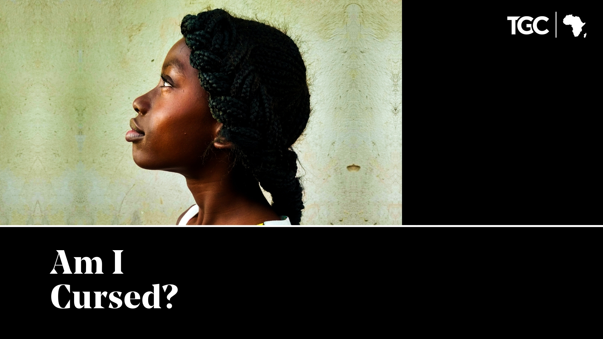 Am I Cursed - Zambian woman looking up with plain wall background