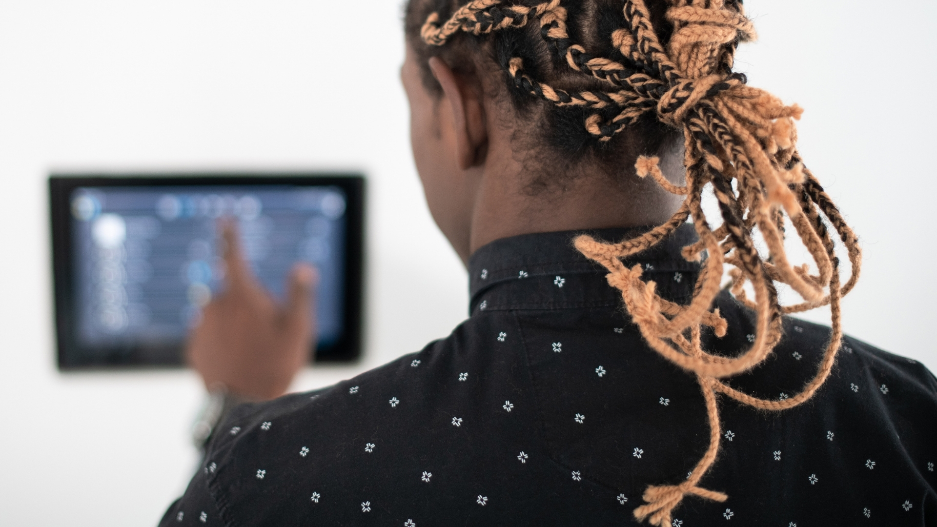 Top Videos of 2020 on TGC Africa: African man from behind - selected a video on an iPad