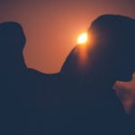 Angel worship is idolatry: Stone angel with the sun setting behind it