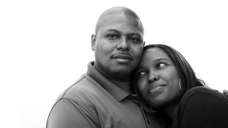 Gender roles in marriage - Aouth African couple embracing looking calm and happy