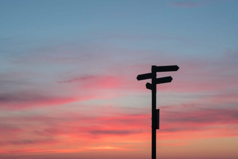 How to take big decisions wisely - signpost on a sunset sky
