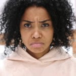 Dealing with church hurt: African woman looking very upset in pink top