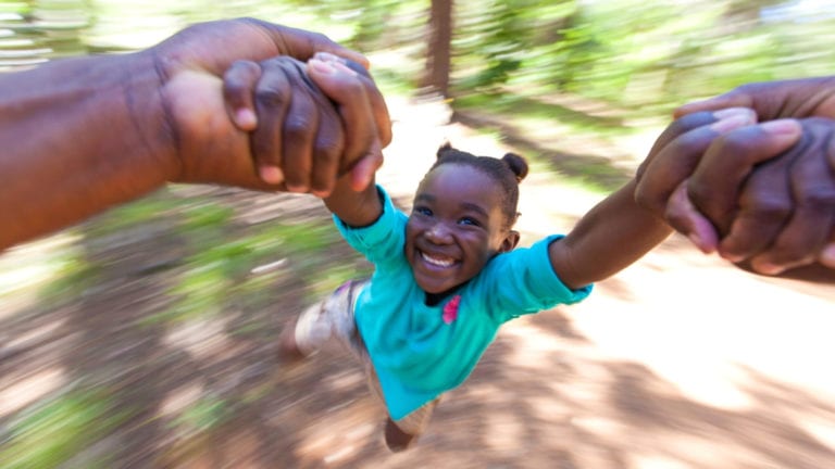 The joy of authentic humility - little African girl being made to fly by her loving father's hands