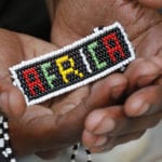 African culture & doing Church - Beaded Africa held in hands of African person