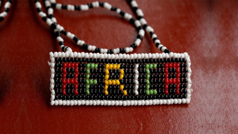 African culture & genuine evangelism - Beaded Africa on a dark red surface