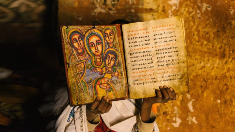 Fathers of the Reformation: Illuminated Ethiopian Bible held by an African