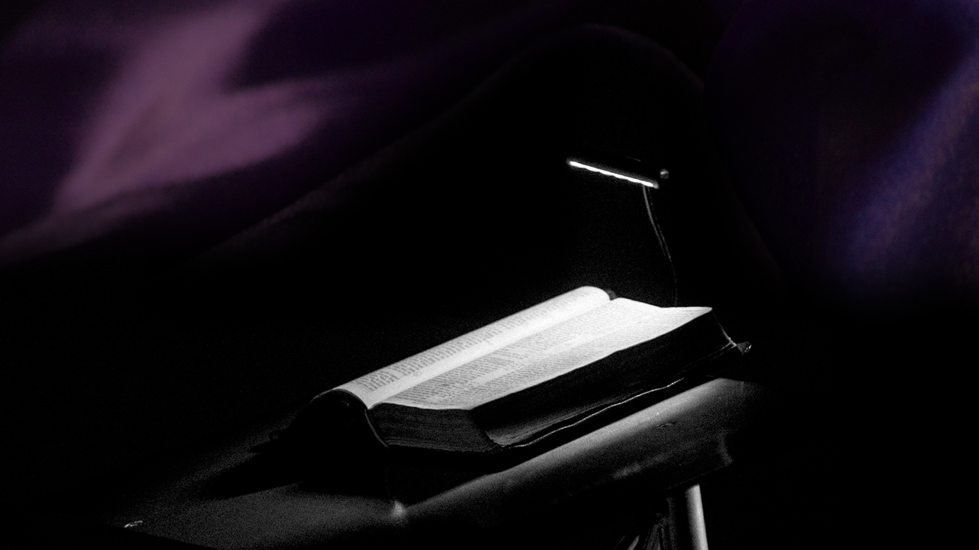 Can I speak against the lord's anointed? A lectern and open bible in a dark space
