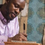 Formal church membership is important in Africa - African pastor writing a list