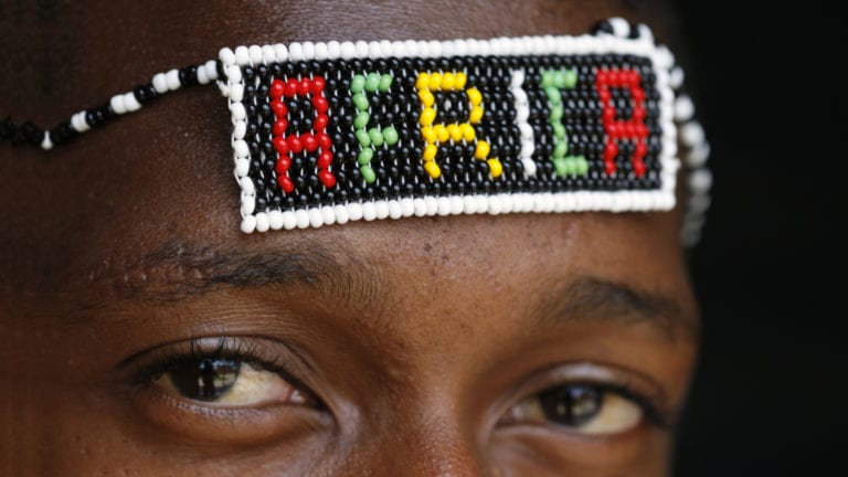 Why Isn't African Christianity impacting African Society? African man with beaded Africa headband