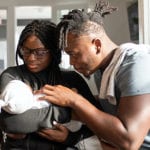 Young African Parents with their baby in a modern apartment