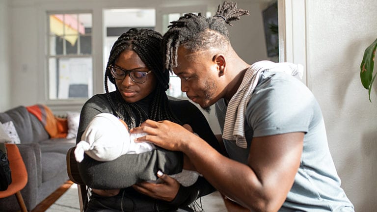 Young African Parents with their baby in a modern apartment