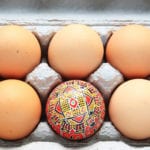 Different on the outside - one painted egg in a tray of hen's eggs