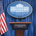 American Politics - Why are we so obsessed? Image of White House press conference podium