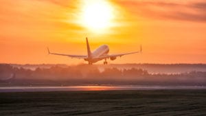 Unpacking The Urge To Leave - plane taking off into the sunset