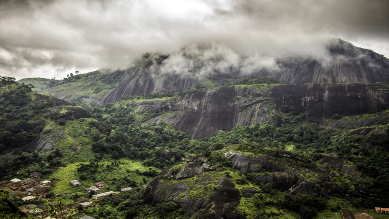 God's Sovereignty - A big mountain with cloudy overcast clouds on the top of the mountain.