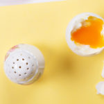 A Different Identity: An egg broken open with a big salt cellar next to it