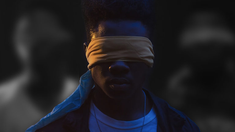 Not being blind to Injustice - A man's face with a brown blindfold over his eyes.