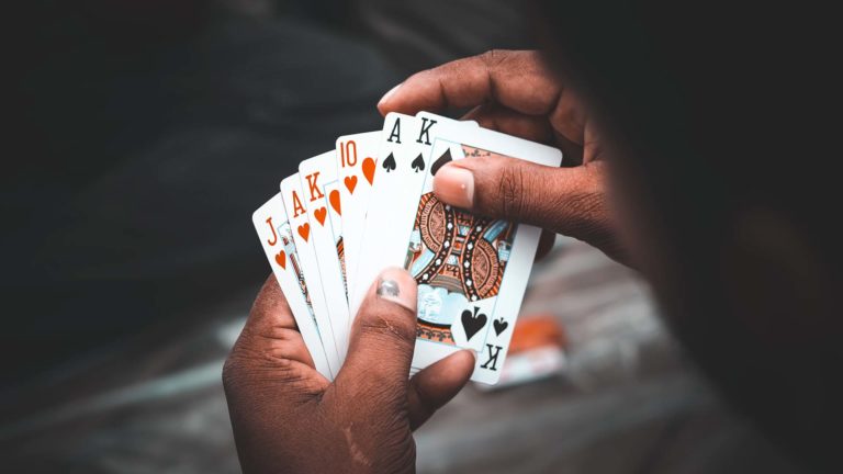Gambling - A person holding a stack of cards in hands