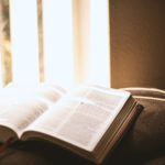 Devotions - A bible lying open on the couch.
