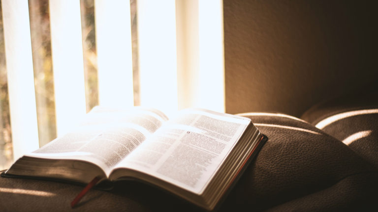 Devotions - A bible lying open on the couch.