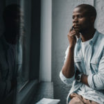 Bible College, your purpose - A man at college staring out the window