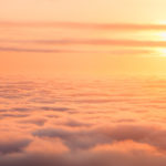 Content in Christ - A sky full of clouds with sun setting.