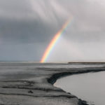 Compassion - A landscape image with a rainbow