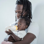 Fatherhood - A Father sitting with his daughter, on his lap